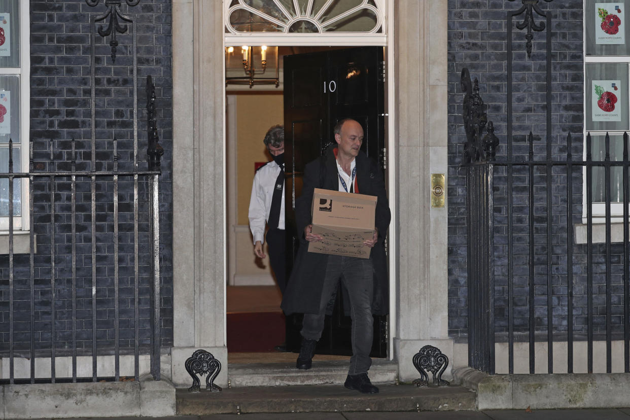 Britain's Prime Minister Boris Johnson's top aide Dominic Cummings leaves 10 Downing Street with a box, in London, Friday, Nov. 13, 2020. Late Wednesday, Lee Cain announced he was quitting as director of communications, a move that has sparked speculation that Dominic Cummings, Johnson's top adviser, could soon leave, further weakening the pro-Brexit camp. Both Cain and Cummings worked together on the 2016 Brexit referendum campaign that was largely fronted by Johnson. (Yui Mok/PA via AP)