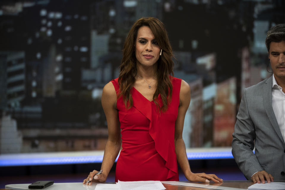 In this March 5, 2020 photo, Diana Zurco stands at the table for news anchors during a rehearsal for her debut as the country’s first transgender newscaster, in Buenos Aires, Argentina. Her job as a co-anchor of Public Television's prime time evening news program is a milestone for an excluded community that is often the target of violence and has a life expectancy roughly half that of the rest of the population. (AP Photo/Victor R. Caivano)