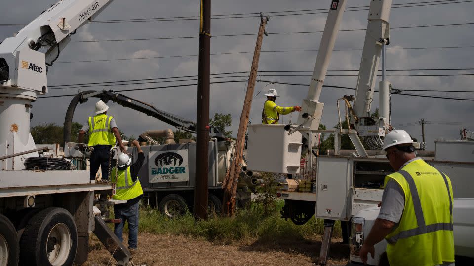 CenterPoint foreign assistance crews work to restore power lines on July 11 in Houston. - Danielle Villasana/Getty Images