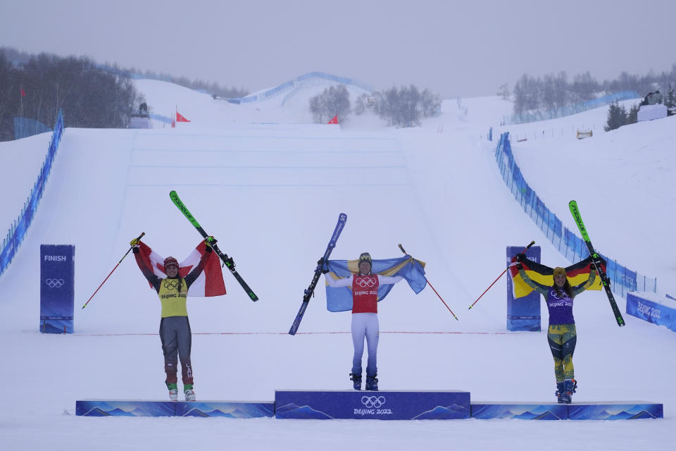 From left silver medal winner Canada's Marielle Thompson, gold medal winner Sweden's Sandra Naeslund and bronze medal winner Germany's Daniela Maier celebrate during the venue award ceremony for the women's cross at the 2022 Winter Olympics, Thursday, Feb. 17, 2022, in Zhangjiakou, China. (AP Photo/Gregory Bull)