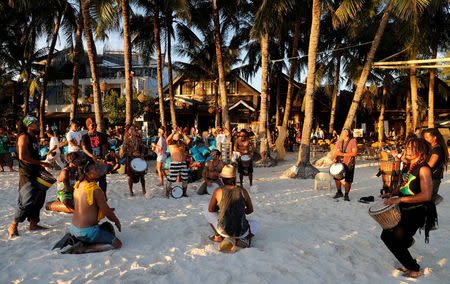 Members of a local band perform on the beach, a day before the temporary closure of the holiday island Boracay, in the Philippines April 25, 2018. REUTERS/Erik De Castro