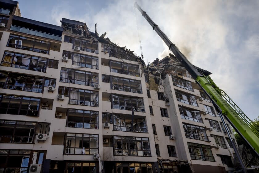 Firefighters at a damaged residential building following explosions in Kyiv, Ukraine, on Sunday.