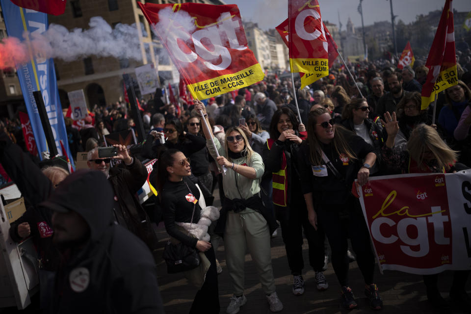 Protesters sing chants during a demonstration in Marseille, southern France, Tuesday, March 7, 2023. Garbage collectors, utility workers and train drivers are among people walking off the job Tuesday across France. They are expressing anger at a bill raising the retirement age to 64, which unions see as a broader threat to the French social model. (AP Photo/Daniel Cole)