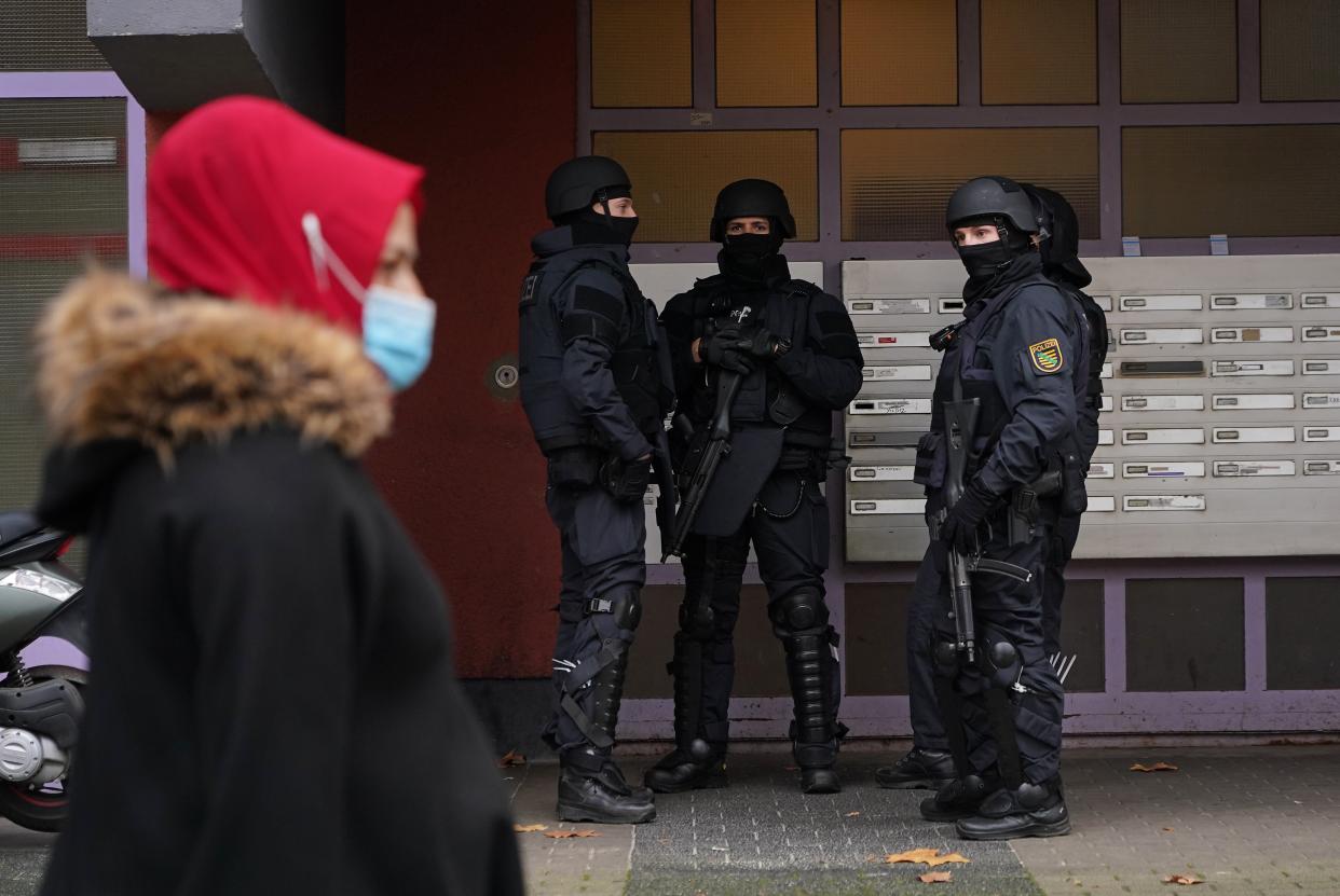 <p>Heavily-armed police standing outside an apartment building in Kreuzberg district</p> (Getty)