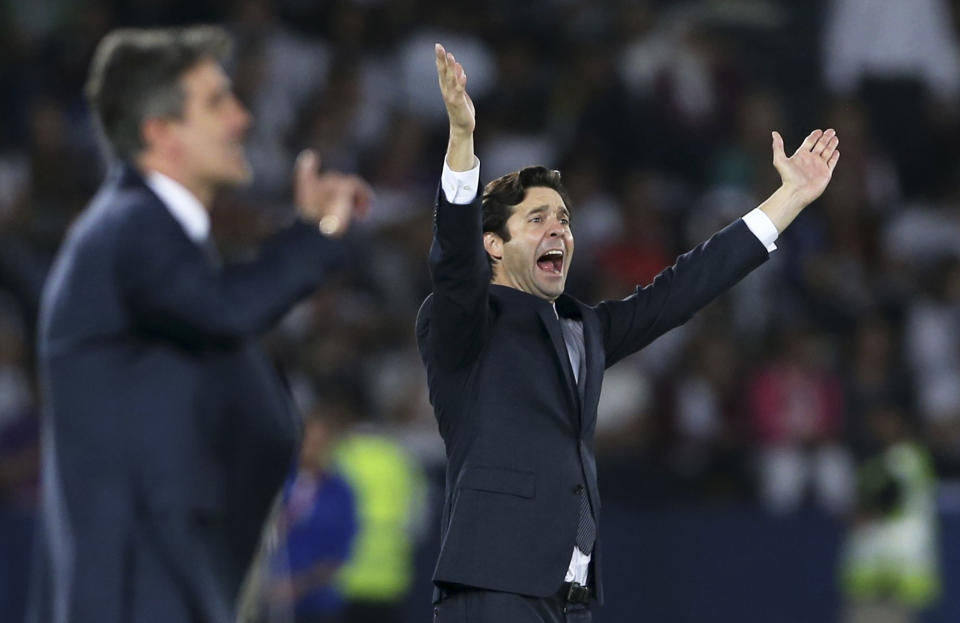 Real Madrid’s coach Santiago Solari and Emirates’s Al Ain head coach Zoran Mamic, left, gesture during the Club World Cup final soccer match between Real Madrid and Al Ain at Zayed Sport City in Abu Dhabi, United Arab Emirates, Saturday, Dec. 22, 2018. (AP Photo/Kamran Jebreili)