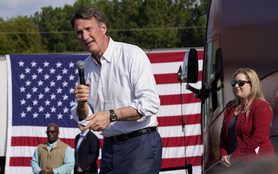 Virginia Gov. Glenn Youngkin, left, addresses the crowd as Del. Kim Taylor, right, listens during an early voting rally Thursday Sep. 21, 2023, in Petersburg, Va. Every Virginia legislative seat will be on the ballot in the November election, and both parties see a possible path to a majority. (AP Photo/Steve Helber)