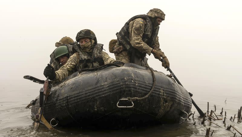 A group of Ukrainian marines sail from the riverbank of Dnipro at the front line near Kherson, Ukraine, on Saturday, Oct. 14, 2023.