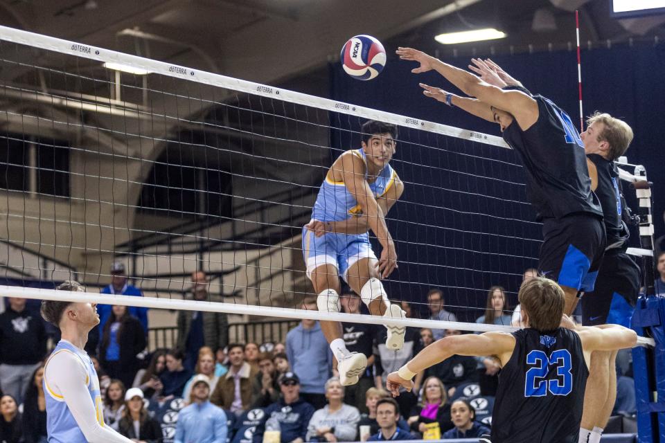 Brigham Young Cougars middle blocker Gavin Julien (10) and setter Tyler Herget (3) block a shot from Long Island Sharks Bio Collazo during an NCAA men’s volleyball match at the Smith Fieldhouse in Provo on Thursday, Feb. 8, 2023. | Marielle Scott, Deseret News