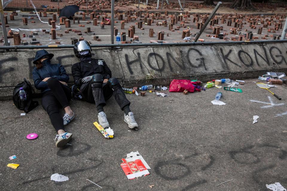 Protesters sleep on a barricaded street outside the university (AFP via Getty Images)