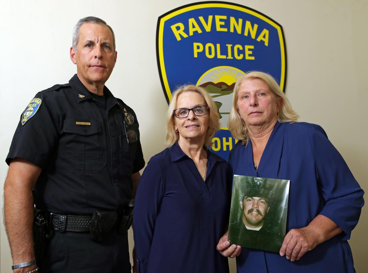 Ravenna Police Chief Jeff Wallis, left, poses with James Wert’s sister Lynn Wagner, center, and James Wert's widow, Rebecca Wert, Wednesday, July 17, 2024, in Ravenna. Patrolman James Wert was killed by a drunken driver in 1981 and will have a section of State Route 88 named in his honor.