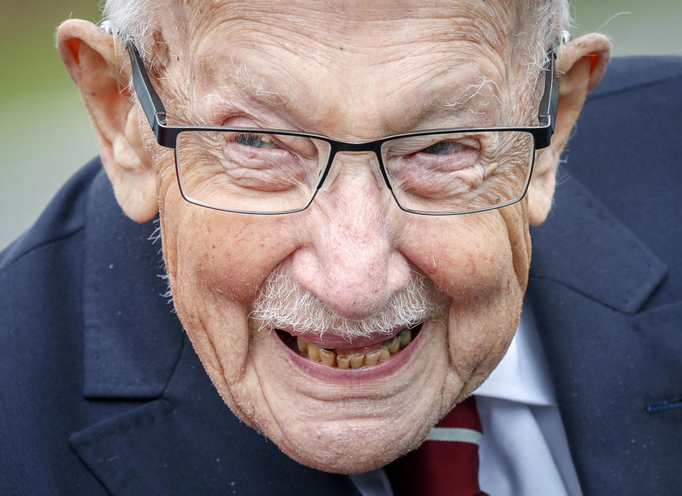 FILE - In this Aug. 3, 2020 file photo, Captain Tom Moore smiles during a visit to the Army Foundation College in Harrogate, North Yorkshire as part of his new role as Honorary Colonel of the Northern military training establishment The legacy of Capt. Tom Moore, the super fundraiser who died Tuesday, Feb. 2, 2021 of COVID-19, lives on in Imogen Papworth-Heidel — and many others. The 11-year-old soccer player, who dreams of playing for England, watched Capt. Tom pushing his walker up and down his garden to raise money for the National Health Service. So she decided to help by doing something she’s good at: keepy uppies — kicking the ball into the air and passing it from one foot to the other without letting it touch the ground. Imogen was able to raise 15,000 pounds ($20,500) for key workers. (Danny Lawson/PA via AP, File)