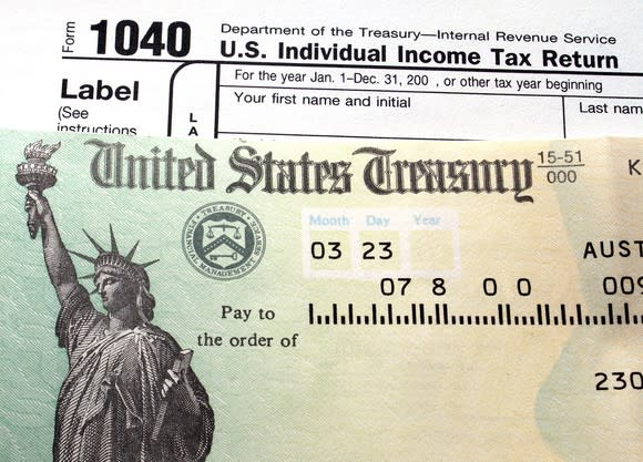 Refund check on top of 1040 tax form.
