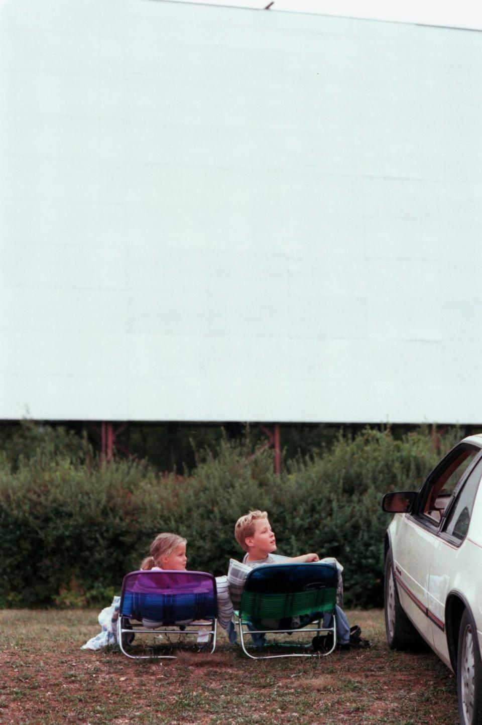 Heather Wance,7, and Sean Wance , 11, of Altoona talk to their parents in the car before watching a movie at the Starlite Drive-In Theatre on Saturday, July 31, 1999.