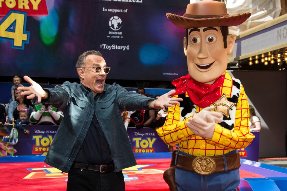 Actor Tom Hanks poses for photographers with his Toy Story character 'Woody', upon arrival at the screening for 'Toy Story 4' in London, Sunday, June 16, 2019. (Photo by Joel C Ryan/Invision/AP) ORG XMIT: LENT108