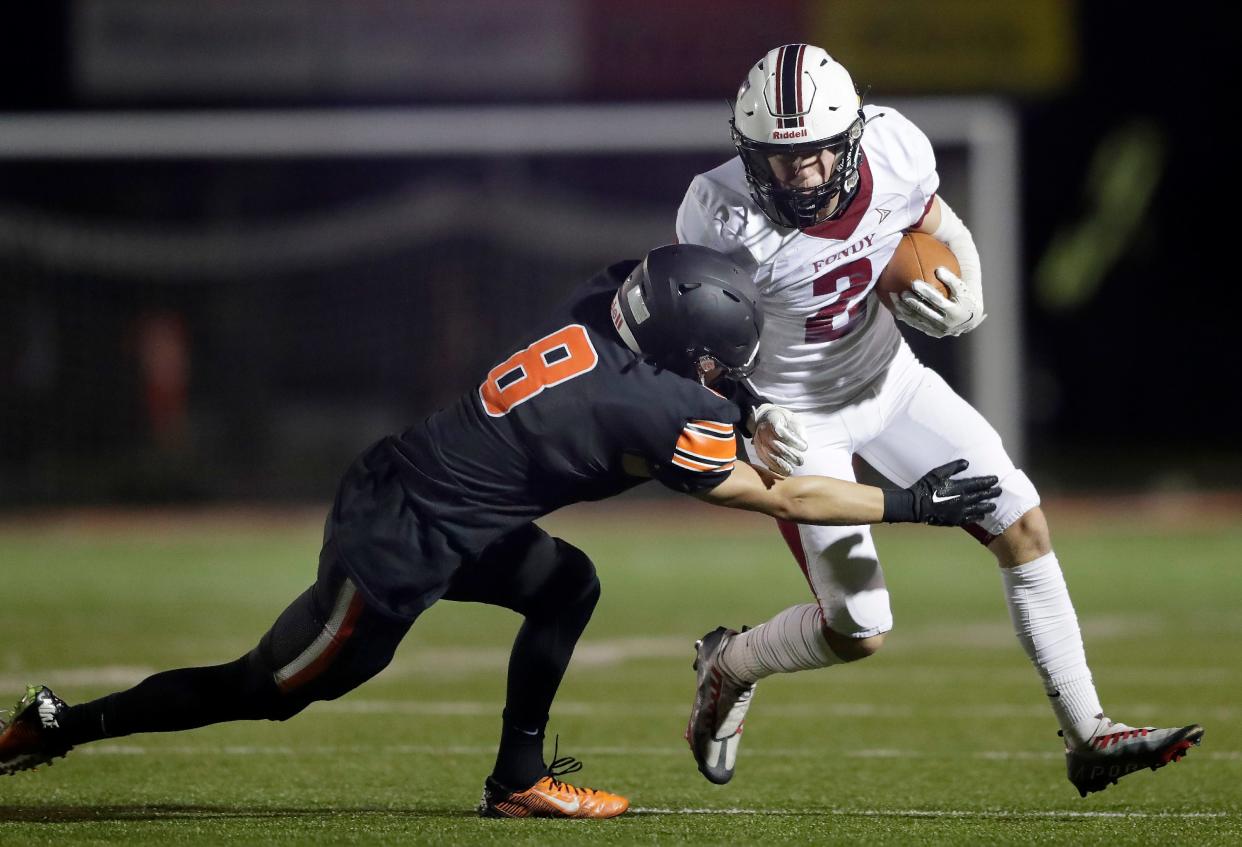 Kaukauna's Payton Miller (8) runs against Fond du Lac's Tyler Brandner (2) during their football game Friday in Kaukauna.