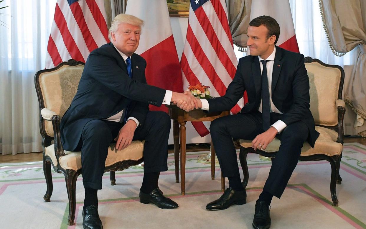 US President Donald Trump and French President Emmanuel Macron's white-knuckle handshake became infamous - AFP