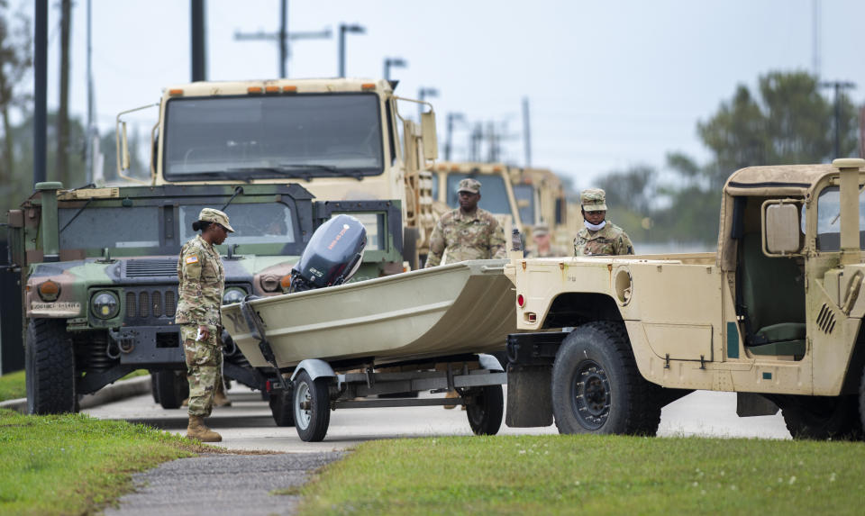 Dozens of boats trailered behind humvees are parked and ready to roll as Louisiana National Guardsmen gather in front of Jackson Barracks as the New Orleans area prepares for Hurricane Zeta on Wednesday, Oct. 28, 2020. (Chris Granger/The Times-Picayune/The New Orleans Advocate via AP)