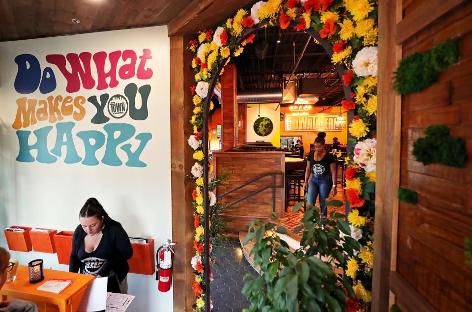 Guests are welcomed at Town Tavern by a mural and floral decor at the entrance Wednesday, Sept. 20, 2023, in Copley, Ohio.