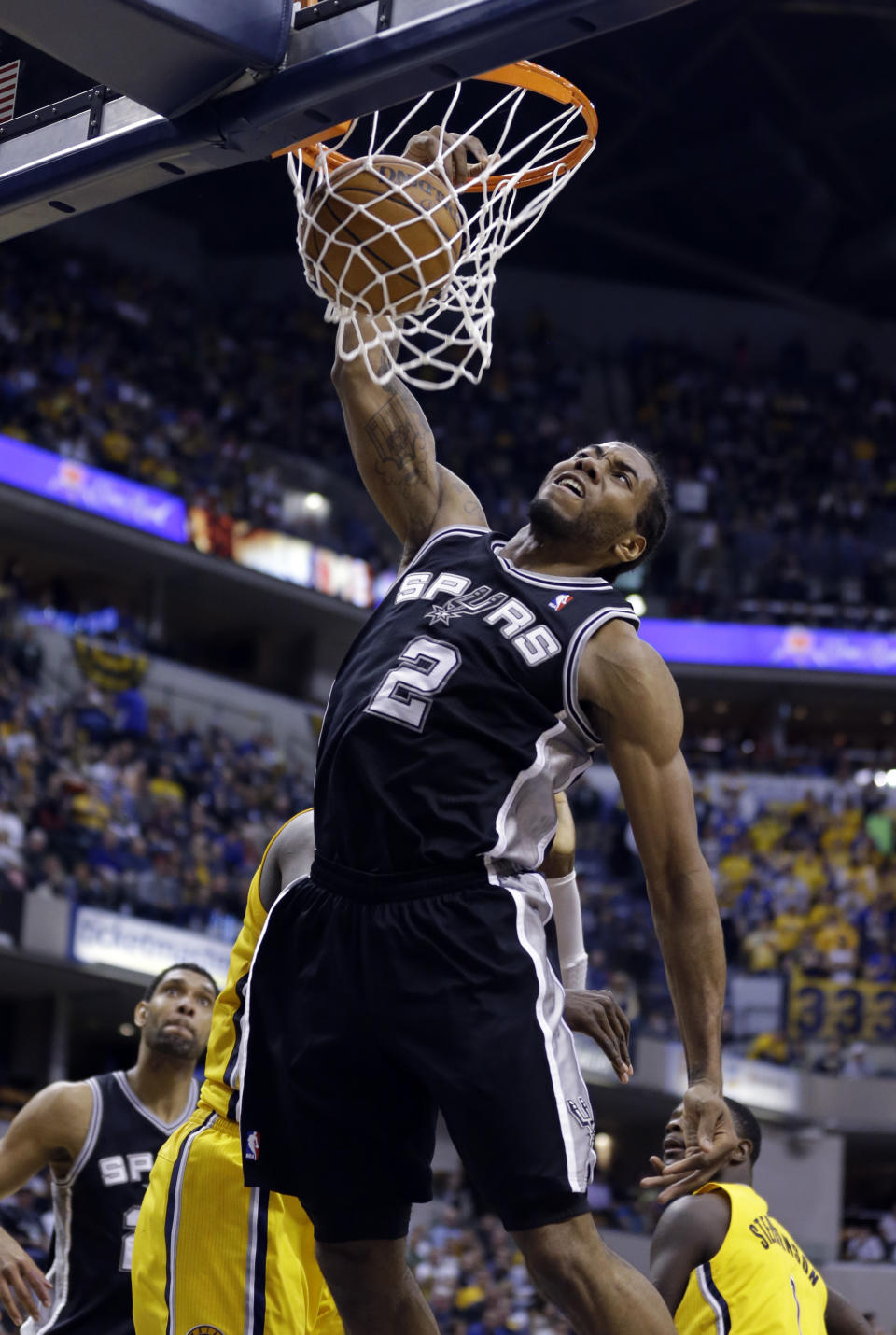 San Antonio Spurs forward Kawhi Leonard gets a dunk against the Indiana Pacers in the second half of an NBA basketball game in Indianapolis, Monday, March 31, 2014. The Spurs defeated the Pacers 103-77. (AP Photo/Michael Conroy)
