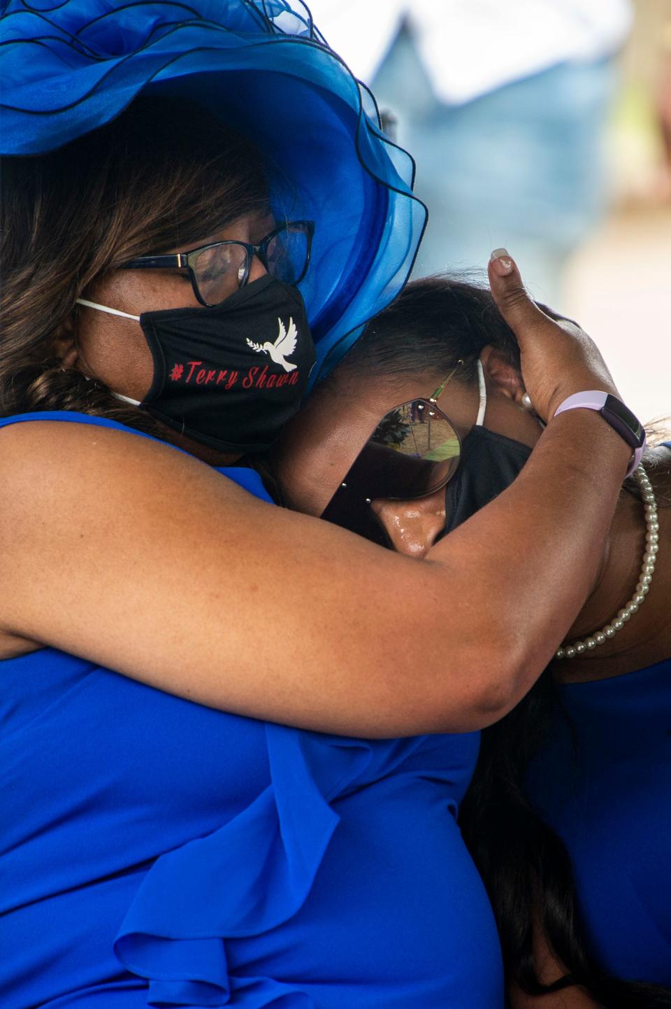 Gussie Newby, the mother of Terry Deshawn Childress, comforts her daughter Elizabeth Hudson during Childress' graveside funeral at Meadowlawn Garden of Peace on Saturday, March 13, 2021 in Toney, Ala. Childress was an inmate at the Trousdale Turner prison when he was killed in February. Officials have classified his death as a homicide, the third suspected murder at the facility in about a year. 