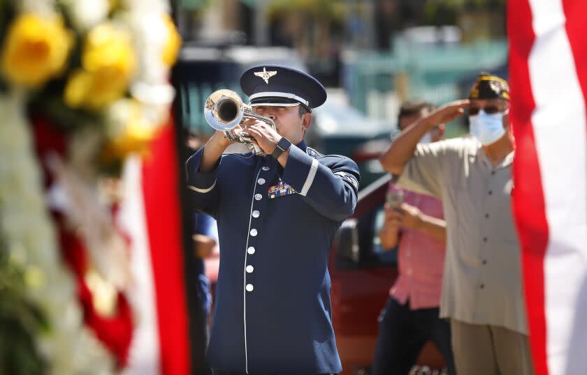 LOS ANGELES-CA-MAY 25, 2020: U.S. Air Force Senior Airman Allan Valladares with the 562nd Air National Guard Band of the West Coast, plays the trumpet at a Memorial Day ceremony at Los Cinco Puntos/Five Points Memorial in East Los Angeles on Monday, May 25, 2020. (Christina House / Los Angeles Times)