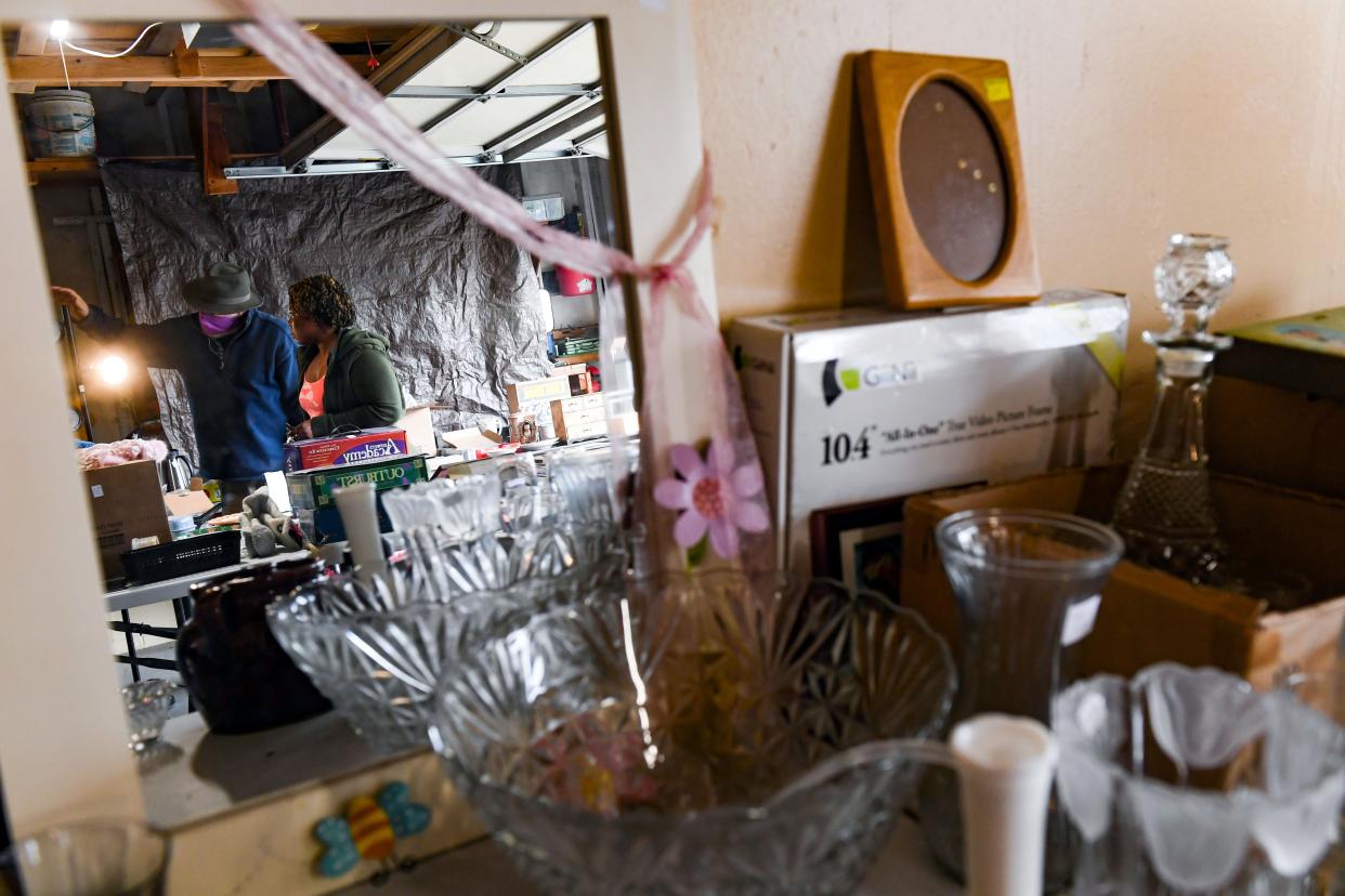 A member of the Lions Club is reflected in a mirror for sale as he directs a visitor to an item of interest during the Kingswood Rummage Sale on Wednesday, April 28, 2021, in Sioux Falls.