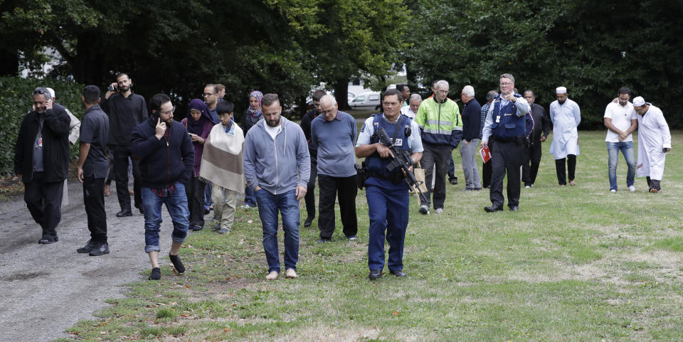 Police escort witnesses away from a mosque in central Christchurch, New Zealand, Friday, March 15, 2019. Multiple people were killed in mass shootings at two mosques full of people attending Friday prayers, as New Zealand police warned people to stay indoors as they tried to determine if more than one gunman was involved. (AP Photo/Mark Baker)