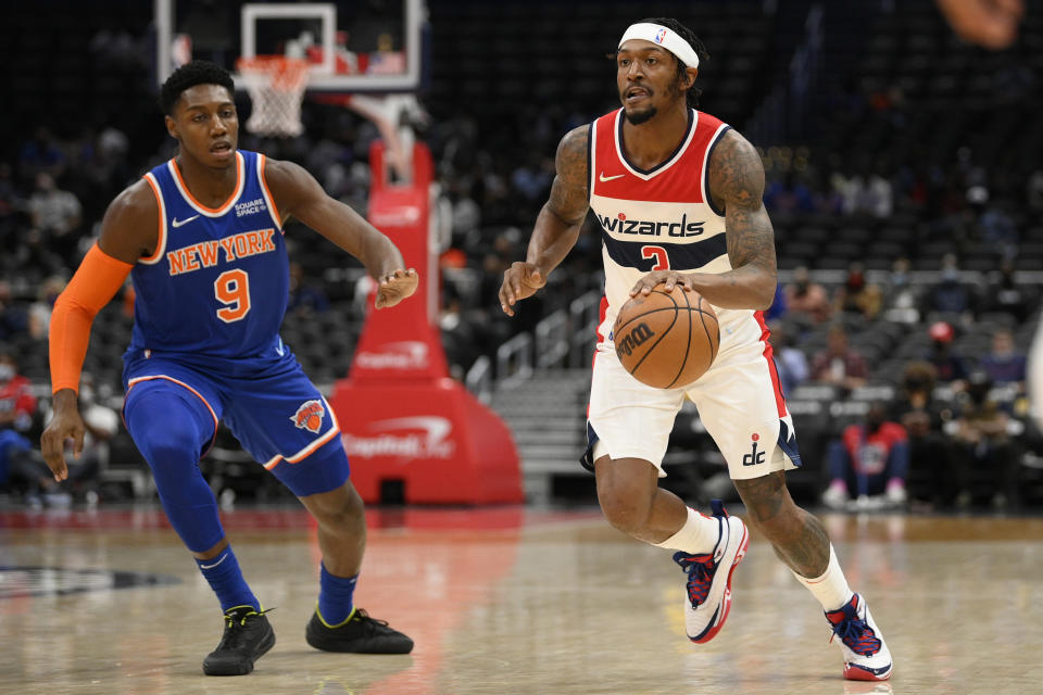 Washington Wizards guard Bradley Beal (3) dribbles the ball next to New York Knicks guard RJ Barrett (9) during the first half of an NBA preseason basketball game, Saturday, Oct. 9, 2021, in Washington. (AP Photo/Nick Wass)