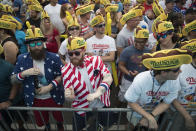 <p>Jeremiah Bruckart, left, and Jared Johnston of the Queens borough of New York dance to the music before the start of the Nathan’s Famous Fourth of July hot dog eating contest, Wednesday, July 4, 2018, in New York’s Coney Island. (Photo: Mary Altaffer/AP) </p>