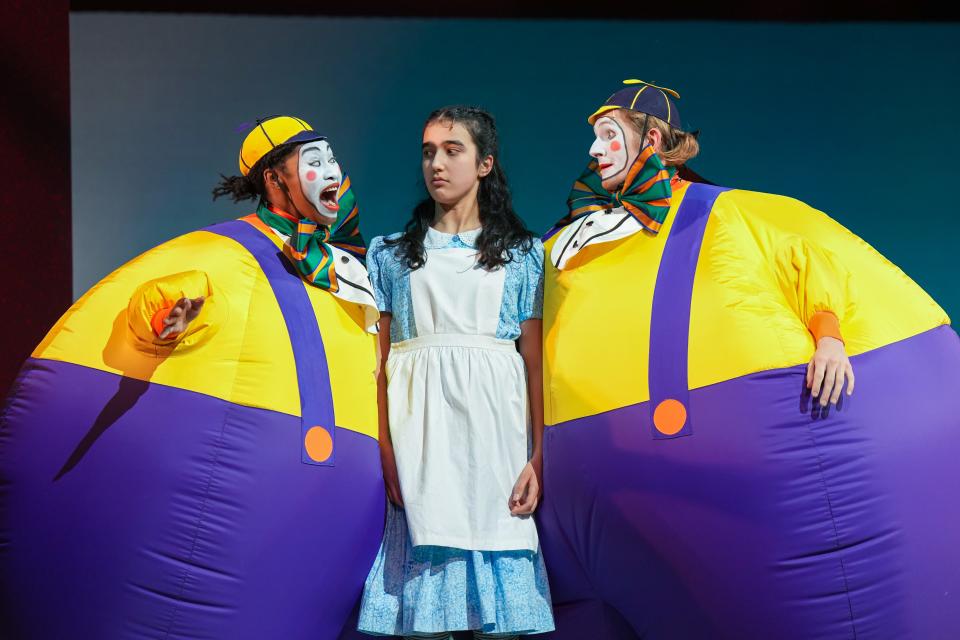 Antonisia Collins, left, as Tweedle Dum, Anja Arora. cemter. as Alice, and Keegan Robinson as Tweedle Dee in Children's Theatre Company's 2024 production of "Alice in Wonderland."