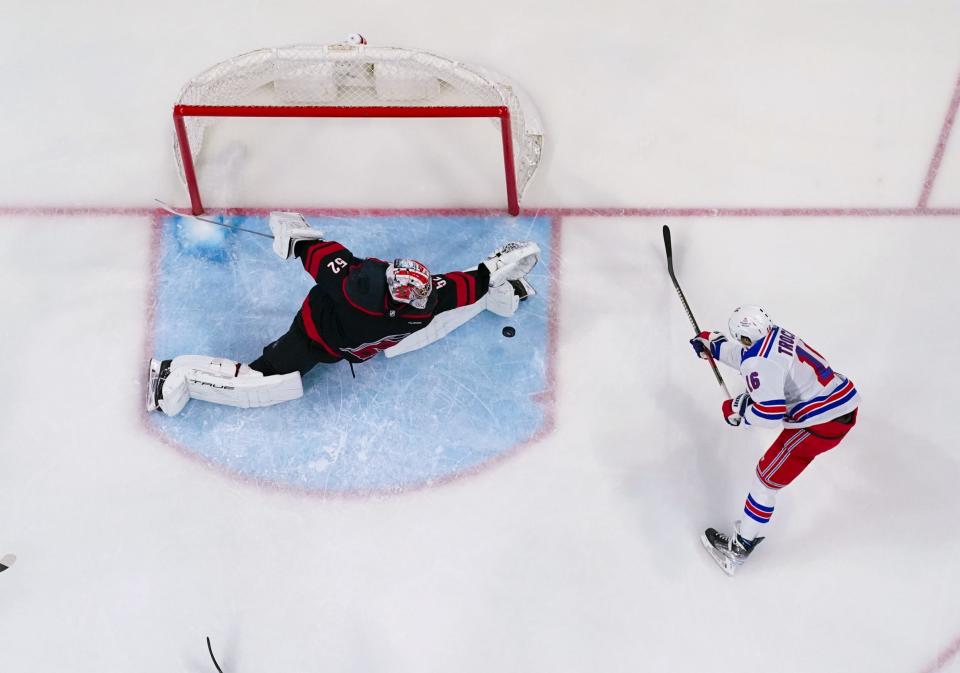 Mar 12, 2024; Raleigh, North Carolina, USA; Carolina Hurricanes goaltender Pyotr Kochetkov (52) stops the scoring attempt by New York Rangers center Vincent Trocheck (16) during the third period at PNC Arena.