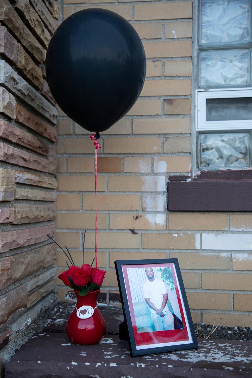 A photograph of Chayne Lee sits next to a balloon during a vigil for Chayne Lee outside of Beulah Grove Missionary Baptist Church in Detroit on Sept. 3, 2022. Chayne Lee was killed last Sunday in Detroit in a random shooting spree that left three people dead.