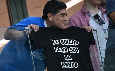 Maradona poses with a t-shirt