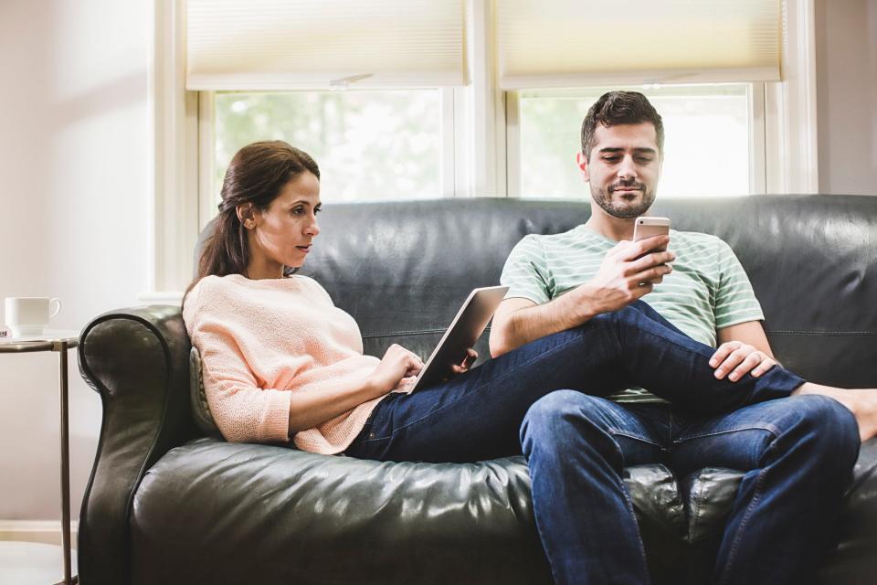 couple at home using devices