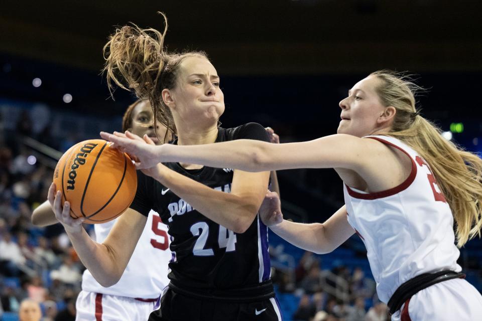 Portland guard Maisie Burnham, left, protects the ball from Oklahoma guard Aubrey Joens during the second half of a first-round college basketball game in the women's NCAA Tournament, Saturday, March 18, 2023, in Los Angeles. (AP Photo/Kyusung Gong)