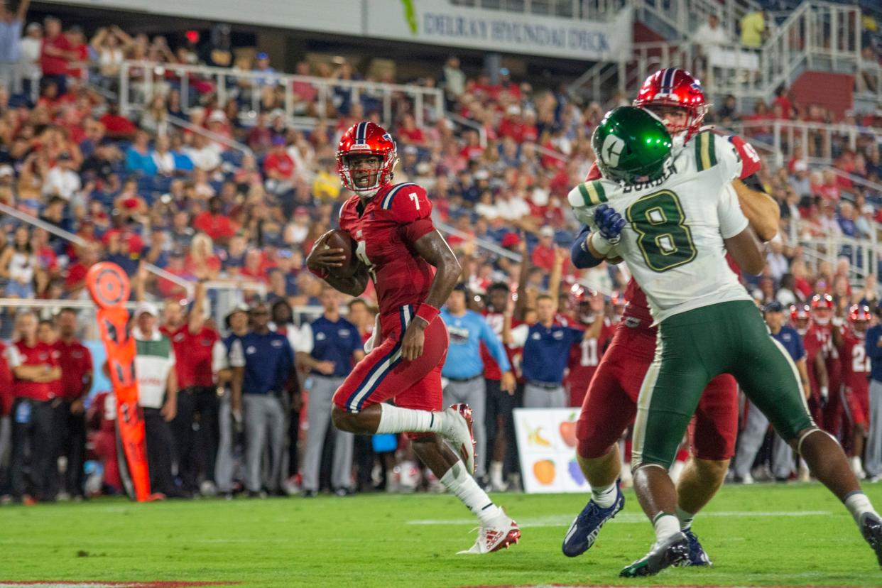 FAU quarterback N'Kosi Perry runs the ball during Saturday night's win.