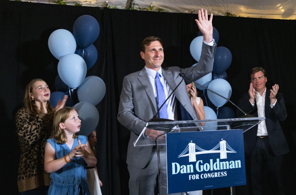Dan Goldman stands with members of his family and supporters during an address on the evening of the Democratic primary election Tuesday, Aug. 23, 2022, in Manhattan, New York. 