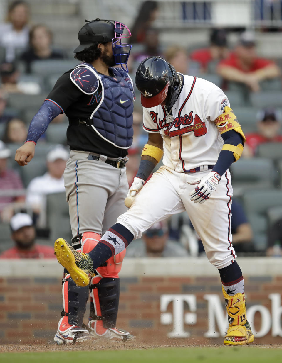 Atlanta Braves' Ronald Acuna Jr., right, kicks dirt after striking out to Miami Marlins' Yimi Garcia in the ninth inning of a baseball game Saturday, July 3, 2021, in Atlanta. (AP Photo/Ben Margot)