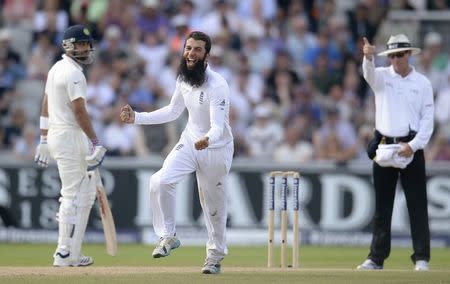 England's Moeen Ali (C) celebrates after dismissing India's Cheteshwar Pujara (not pictured) during the fourth cricket test match at Old Trafford cricket ground in Manchester, England August 9, 2014. REUTERS/Philip Brown