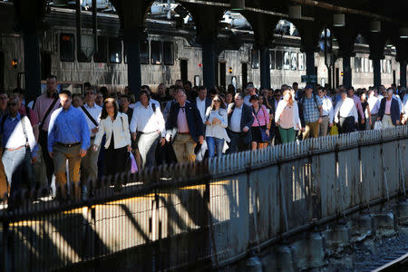 People arrive to the Hoboken Terminal in New Jersey to commute to New York City, U.S., July 10, 2017. REUTERS/Eduardo Munoz