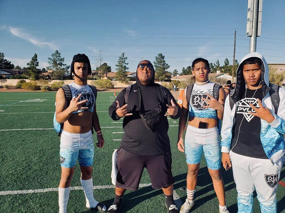 This Feb. 14, 2020, photo provided by Raymond Millare shows from left Raymond Millare, Willie Talamoa, Ej Liua and Fia Tofilau in Las Vegas where their Pylon football team had traveled for a tournament. A Honolulu community is mourning the loss of Talamoa, a mentor, football coach and father figure who died after contracting COVID-19. (Courtesy of Raymond Millare via AP)