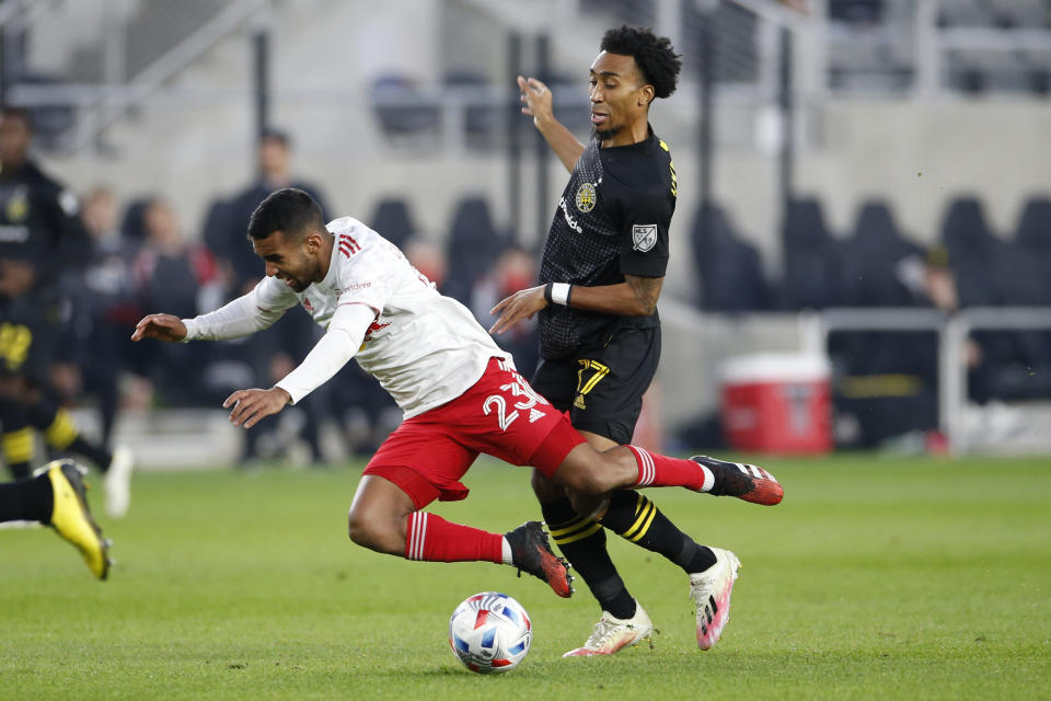 New York Red Bulls' Cristian Casseres, left, and Columbus Crew's Marlon Hairston collide during the first half of an MLS soccer match Saturday, Oct. 23, 2021, in Columbus, Ohio. (AP Photo/Jay LaPrete)