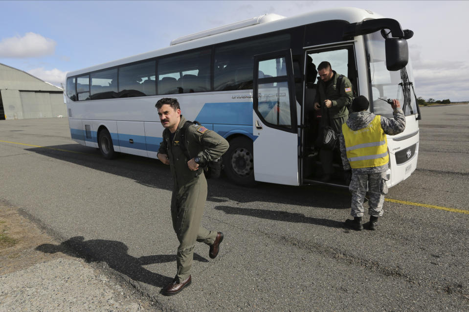 Unites States air force crew arrive to help in the search for a missing C-130 Hercules transport plane, at the Chilean air force base in Punta Arenas, Chile, Wednesday, Dec. 11, 2019. Searchers using planes, ships and satellites were combing the Drake Passage on Tuesday, hunting for the plane carrying 38 people that vanished en route to an Antartica base. (AP Photo/Fernando Llano)