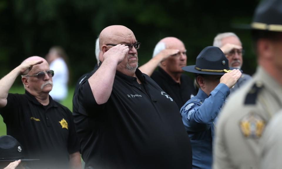 Mourners saluted as Prestonsburg Police Captain Ralph Frasure was laid to rest Wednesday afternoon in the Gethsemane Gardens in Prestonsburg, Kentucky.July 6, 2022