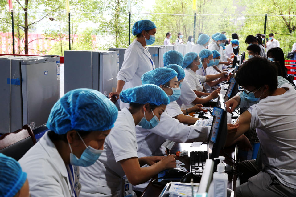 Doctors give Covid-19 vaccine to high schoolers at a temporary vaccination site in Chongqing, China, on June 10, 2021. Source: Getty