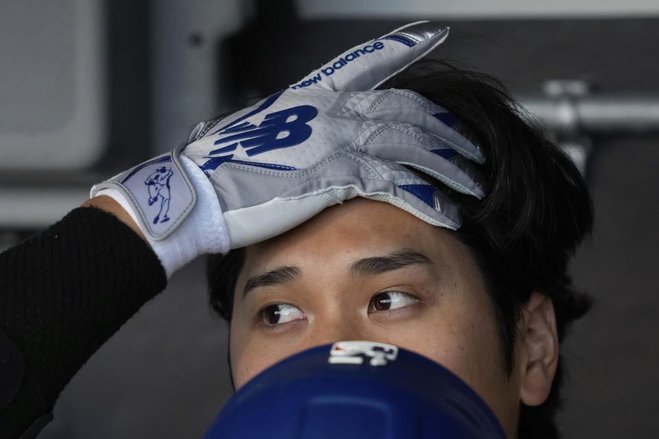 Los Angeles Dodgers' Shohei Ohtani gets ready inside the dugout before the team's baseball game against the San Francisco Giants, Tuesday, May 14, 2024, in San Francisco. (AP Photo/Godofredo A. Vásquez)