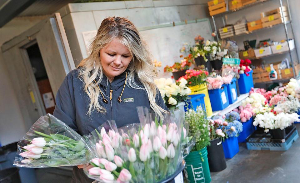 Jill Landry, owner of Beach Plum Floral in Marshfield, arranges florals in her workshop on Monday, May 2, 2022.