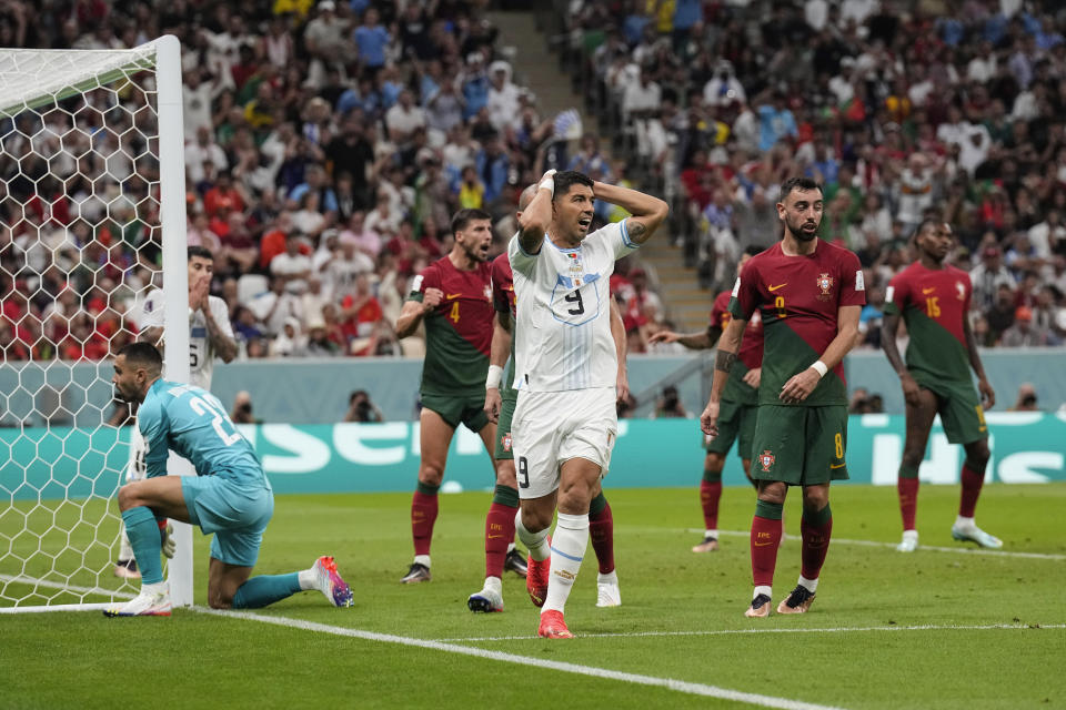 Uruguay's Luis Suarez , center reacts after he missed to score during the World Cup group H soccer match between Portugal and Uruguay, at the Lusail Stadium in Lusail, Qatar, Monday, Nov. 28, 2022. (AP Photo/Martin Meissner)