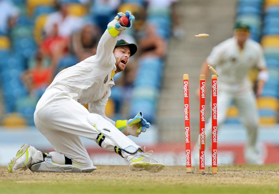 Australian wicketkeeper Matthew Wade breaks the wicket in an unsuccessfull attempt to run out West Indies batsman Devendra Bishoo during the final day of the first-of-three Test matches between Australia and West Indies at the Kensington Oval stadium in Bridgetown on April 11, 2012. AFP PHOTO/Jewel Samad (Photo credit should read JEWEL SAMAD/AFP/Getty Images)