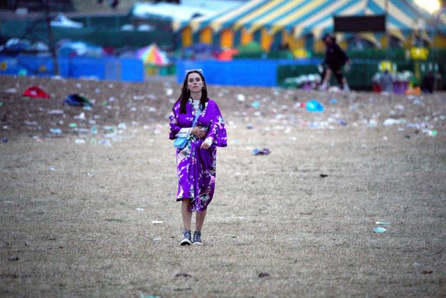 A festival goer wanders round Worthy Farm in Somerset following the Glastonbury Festival